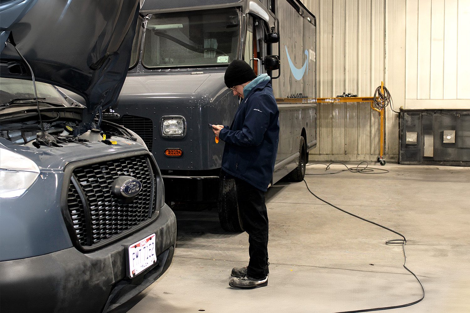 Mechanic stands in 312 Truck Body Repair & Painting garage